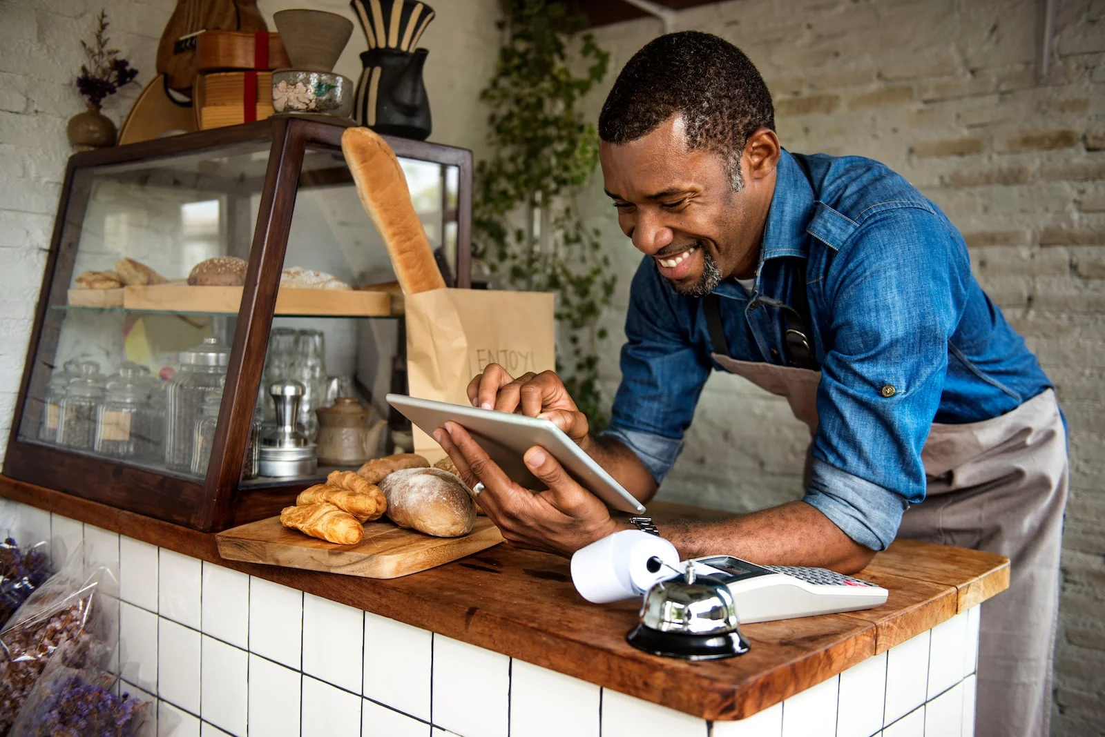 man looking at ipad at bakery